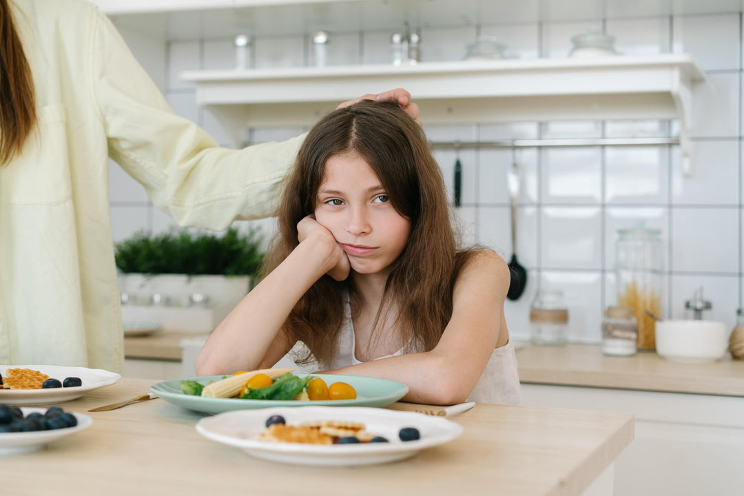 girl not wanting to eat her vegetables